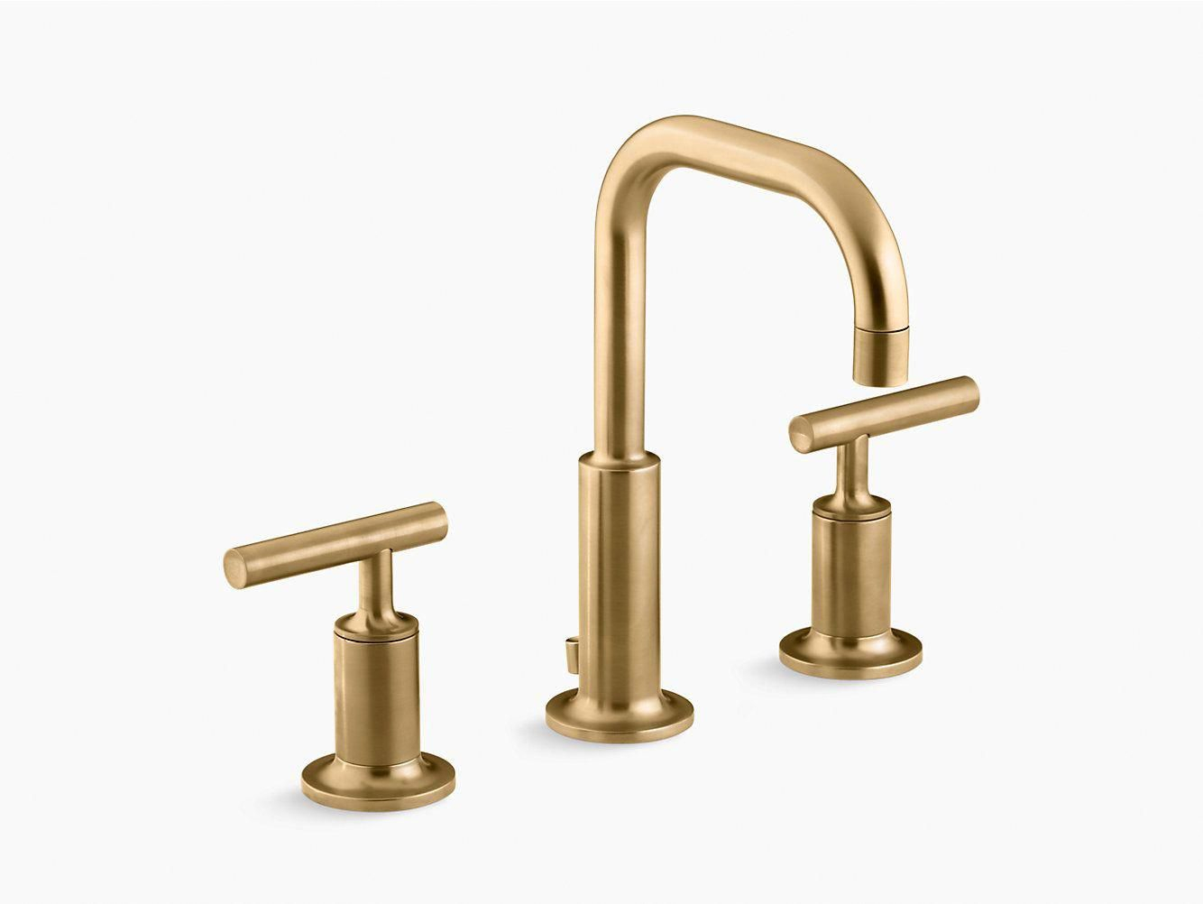 gold tone bathroom sink and shower fixtures